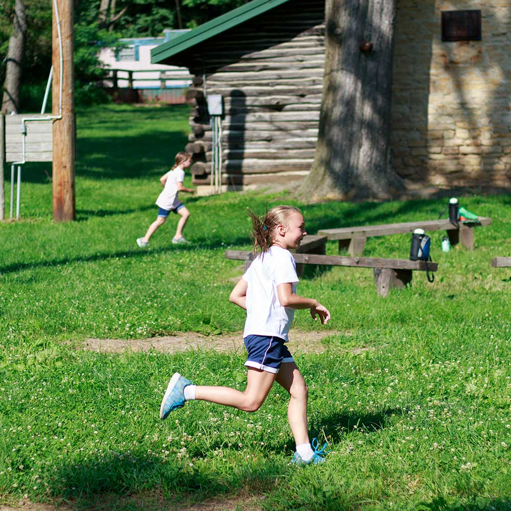 kid running next to cabins